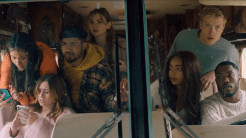 Group of friends in a bus looking nervous.